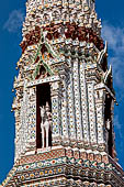 Bangkok Wat Arun - Detail of the niches of each minor prang with statues of Nayu, the god of wind, on horseback. 